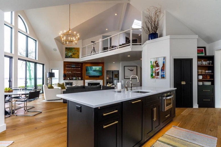 Open kitchen, dining and living spaces in the renovated lake house