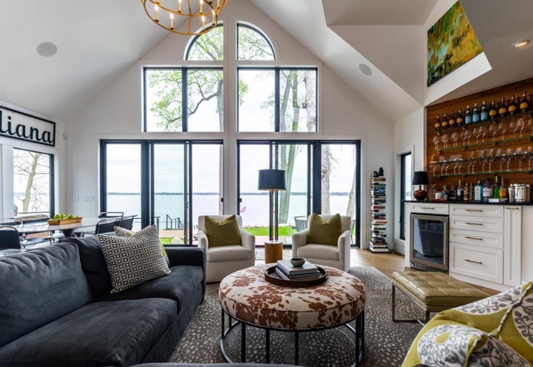 Lake Wawasee living room with expansive lake views, layered furnishings and a custom bar