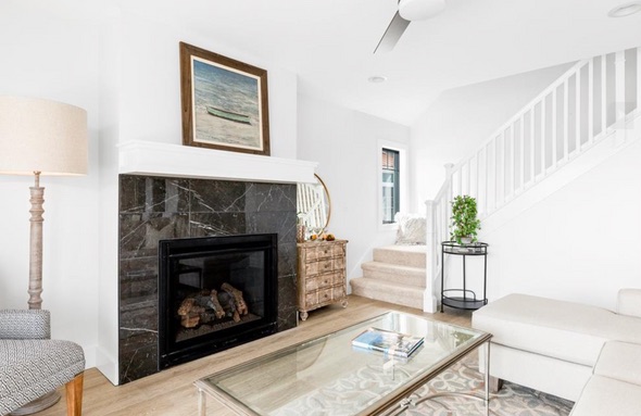 Bright living room with a marble fireplace