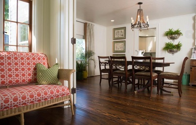 Warm cottage dining area with a patterned settee