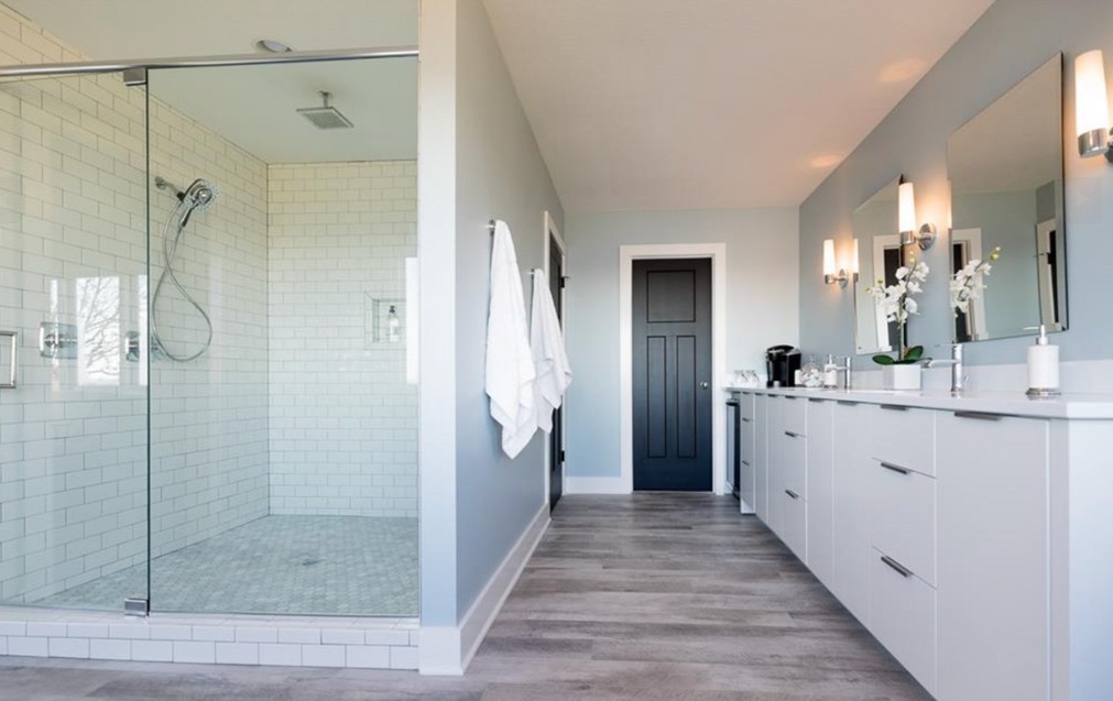 Redesigned primary bathroom with a walk-in shower and double vanity